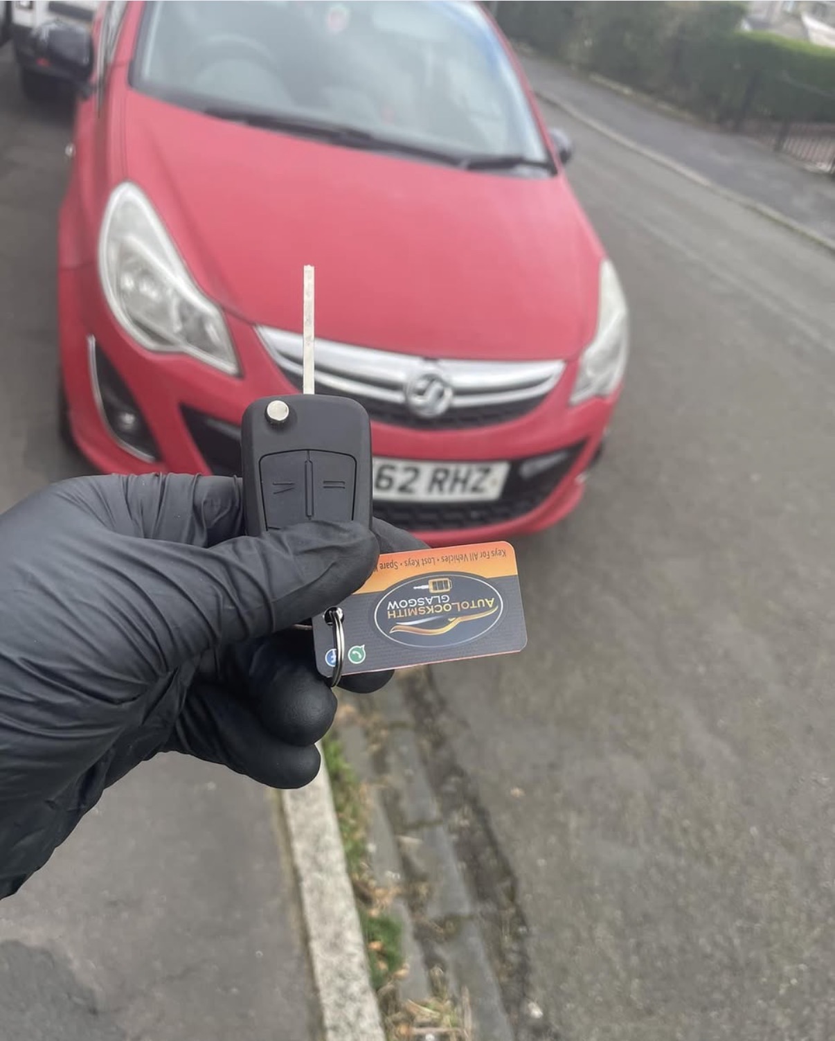 New Vauxhall Corsa flip key held in front of the red car