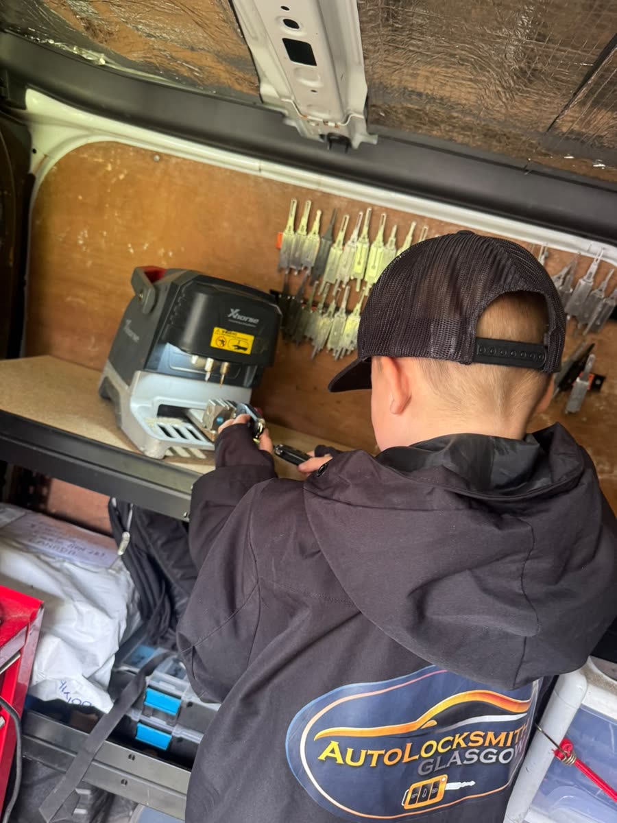 Autolocksmith Glasgow cutting a car key on the Xhorse machine in the van